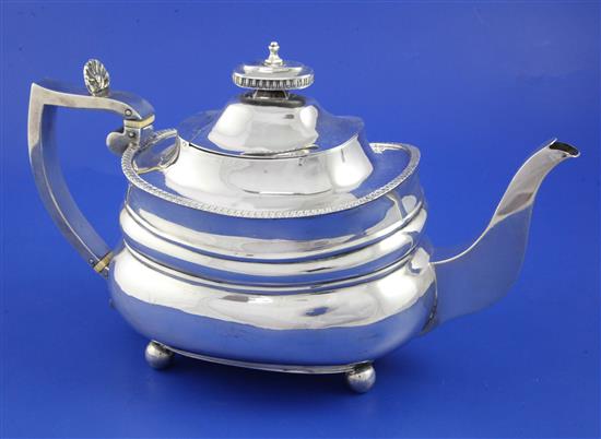 An Edwardian Regency style silver teapot, gross 22 oz.